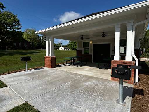 A covered picnic area with a mailbox in front.