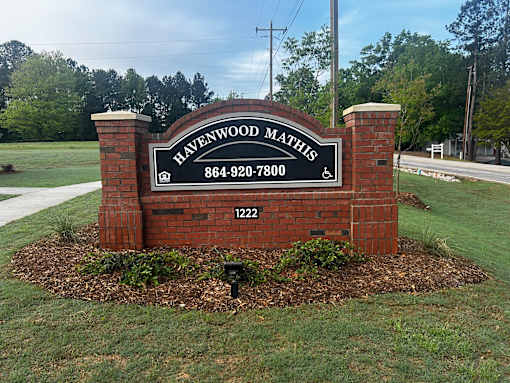 A sign for Havenwood Maths with a phone number and address.