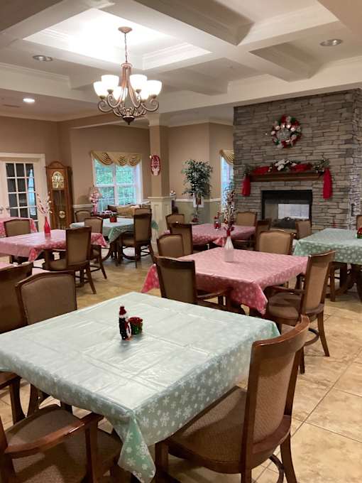 A dining room with a table set for a meal.