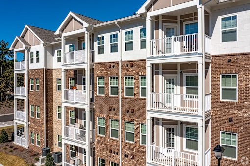 A large apartment building with balconies and multiple stories.