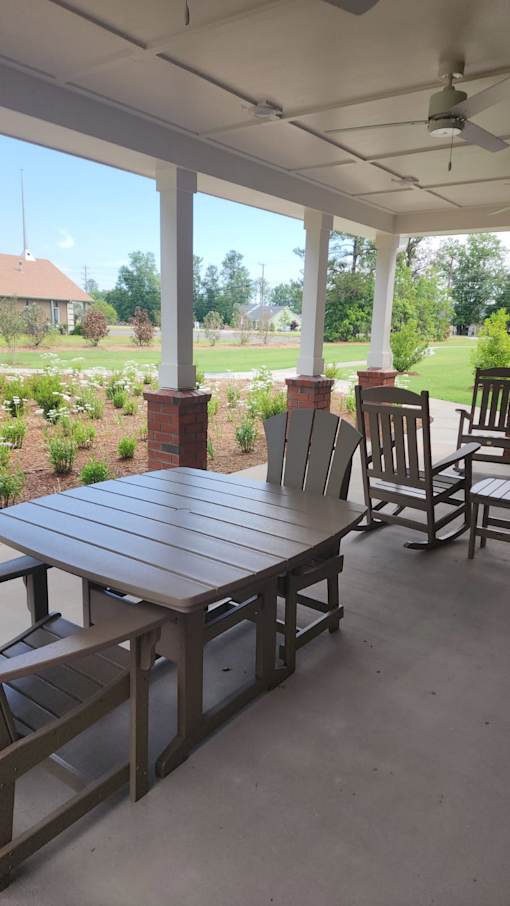 A patio with a table and chairs.
