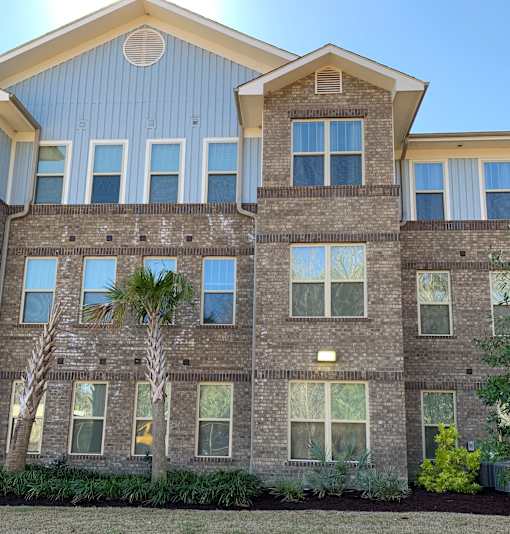 A building with a mix of brick and siding exterior.