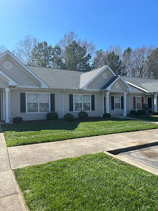 A house with a grey facade and white trim.