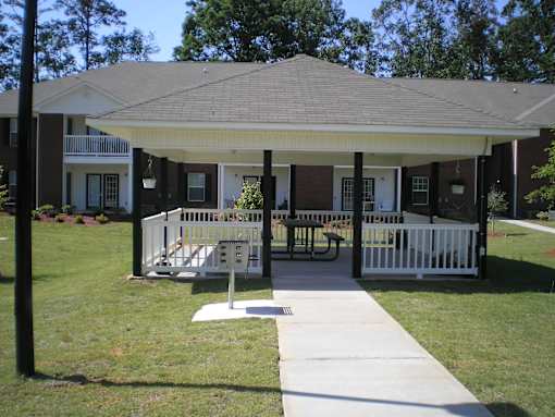 A covered patio area with a table and chairs.