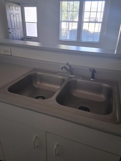 A kitchen with two sinks and a window.