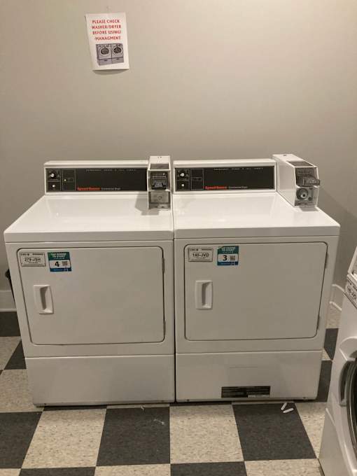 A washing machine with a black and white checkered floor.