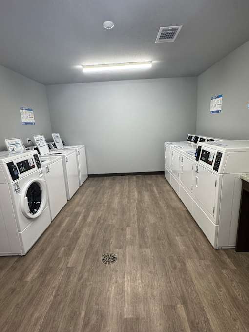 A row of washing machines in a laundromat.