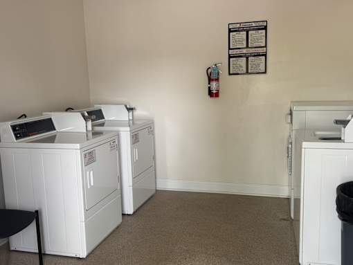 A room with a fire extinguisher and a sign on the wall.