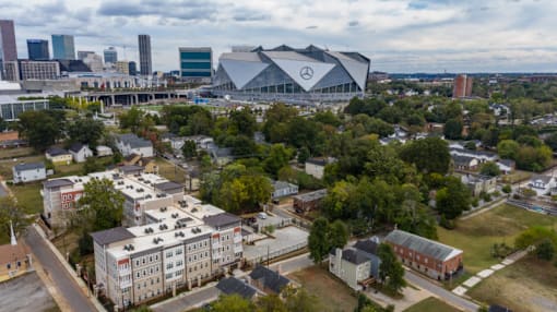 A Mercedes-Benz stadium is seen in the distance behind a parking lot.