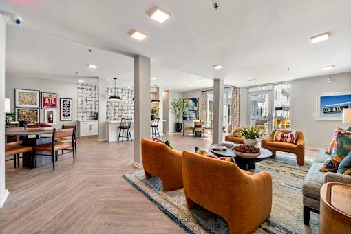 A living room with a couch, chairs, and a coffee table.