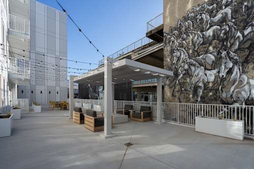 A large mural of horses is on the side of a building.
