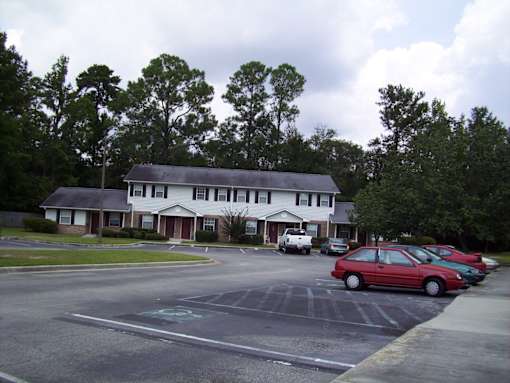 A red car is parked in a parking lot.