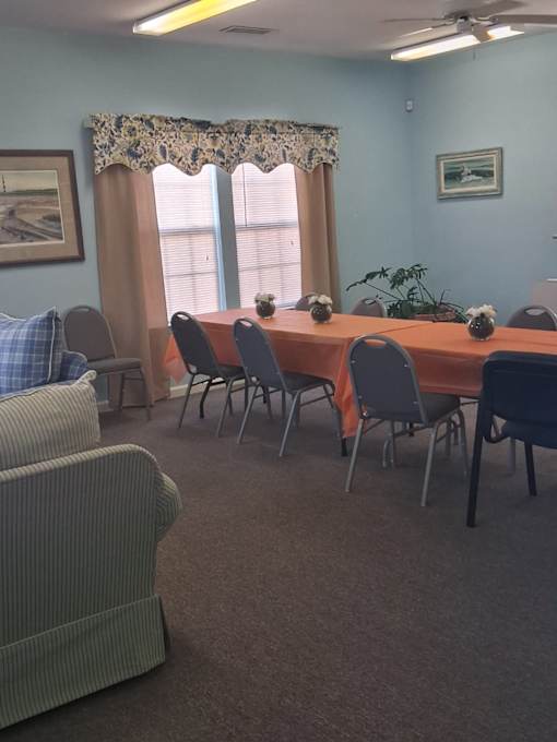 A room with a table, chairs, and a sofa.