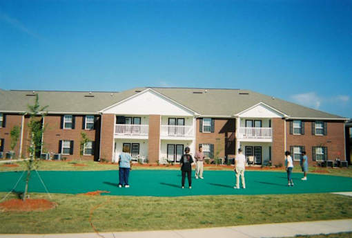 A group of people are standing in front of a building.