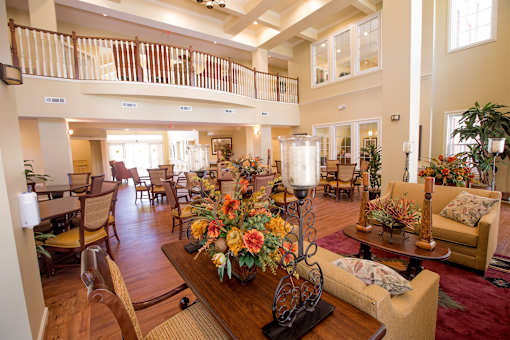 A large, well-decorated living room with a balcony.