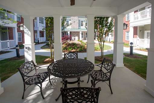 A patio with a table and chairs.