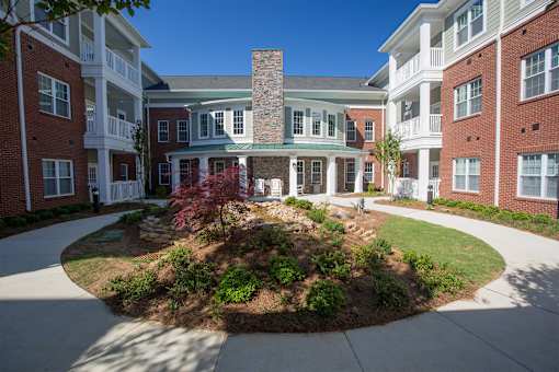 A courtyard surrounded by red brick buildings.