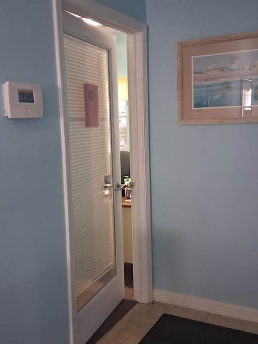 A white door with a red sign on it.