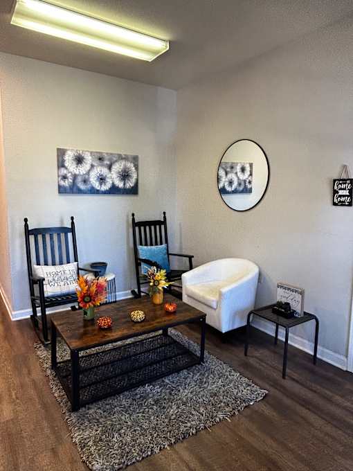 A living room with a couch, a chair, and a coffee table.