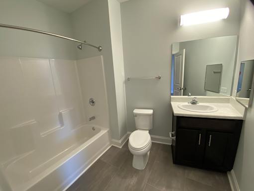 A white toilet sits next to a sink in a bathroom.