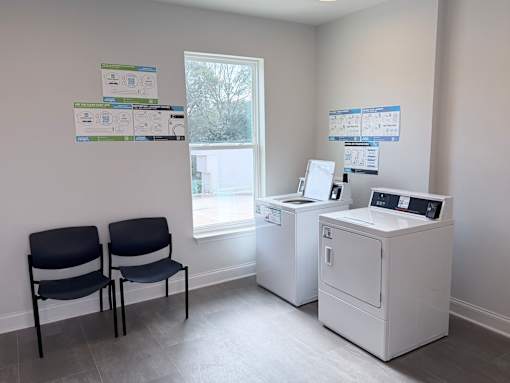 Two chairs are placed in front of a window in a room.