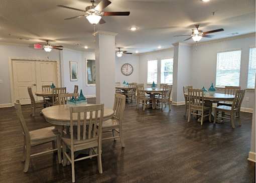 A dining room with wooden floors and furniture.