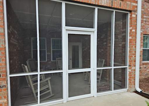 A glass door with a white frame is open.
