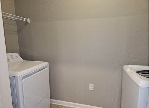 A laundry room with a washer and dryer.