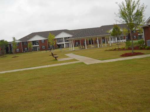 A large building with a grassy area in front.