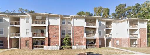 Apartment building with balconies and doors visible.