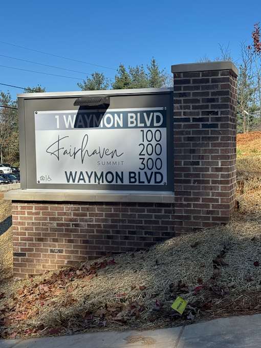 A street sign for 12th Ave and Waymon Blvd is shown.