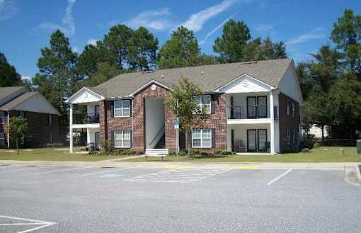 A building with a parking lot in front of it.