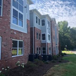 A row of red brick houses with white trim.