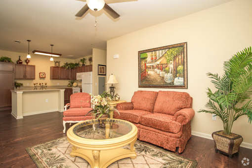 A living room with a red couch and a coffee table.