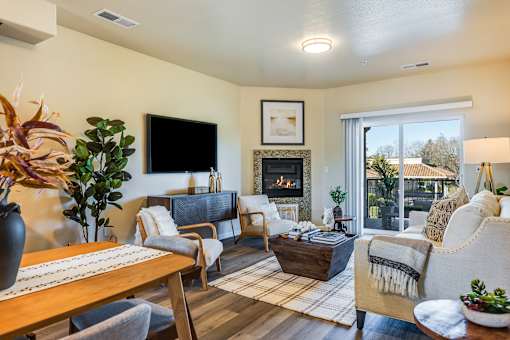 A living room with a fireplace and a flat screen TV.