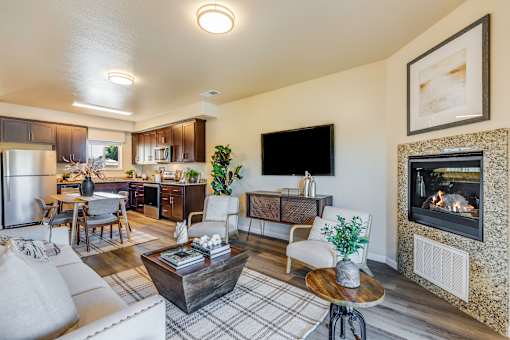 A modern living room with a fireplace and a flat screen TV.
