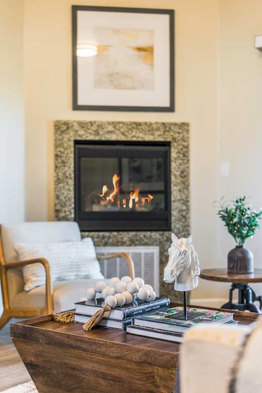 A living room with a fireplace and a chair.