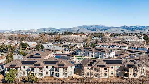 A suburban neighborhood with houses and mountains in the background.