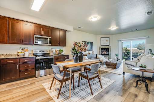 A modern kitchen with a dining table and chairs.