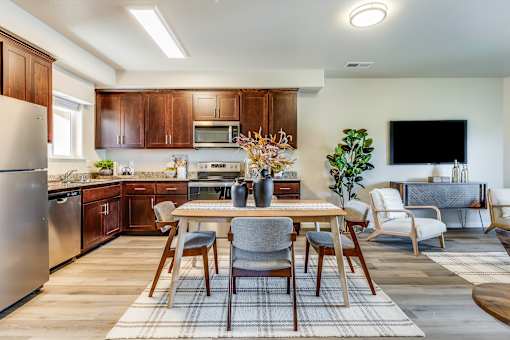 A modern kitchen with a dining table set for four.