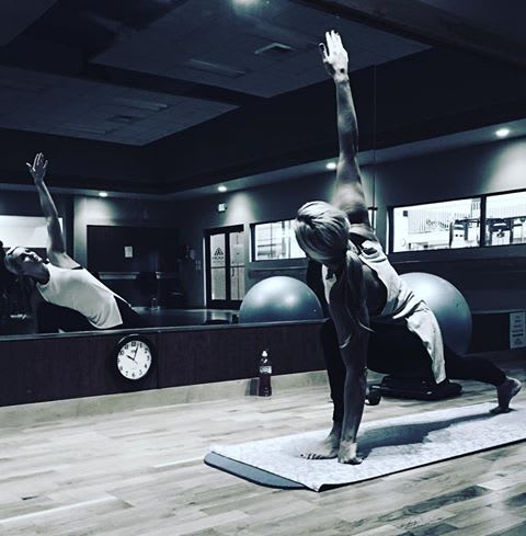 Two people doing yoga in a dimly lit room  at Ironwood Apartments, Coeur d'Alene, ID