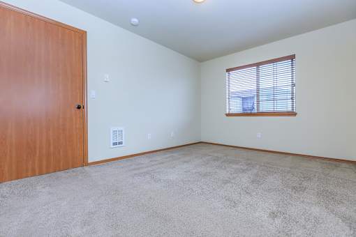 Empty bedroom with carpet and window blinds at Monroe Avenue Apartments, Salem