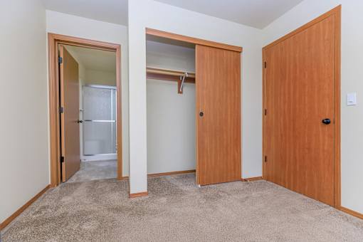 Bedroom with walk-in closet and private bathroom at Monroe Avenue Apartments, Oregon