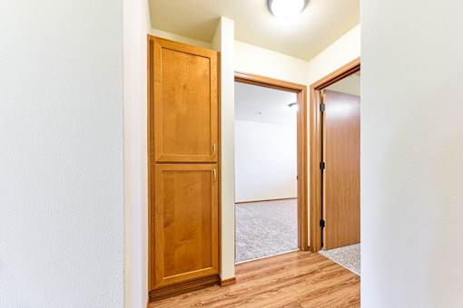 Hallway with builtin storage and wood flooring at Monroe Avenue Apartments, Oregon, 97301