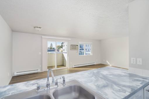 A kitchen with a marble countertop and a double sink. at Ironwood Apartments, Coeur dAlene, ID, 83814