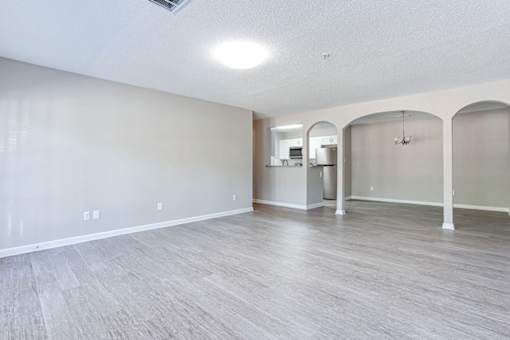 A spacious room with light grey flooring and white walls at Ballantyne Commons of Stockbridge Apartments, Stockbridge, GA, 30281