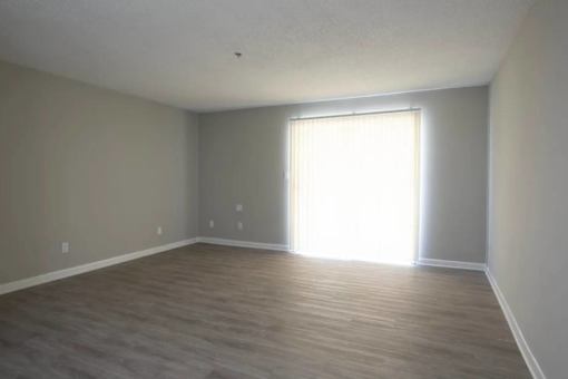 A room with light coming through a window at The Madison Apartments and Townhomes, Lawrenceville, 30044