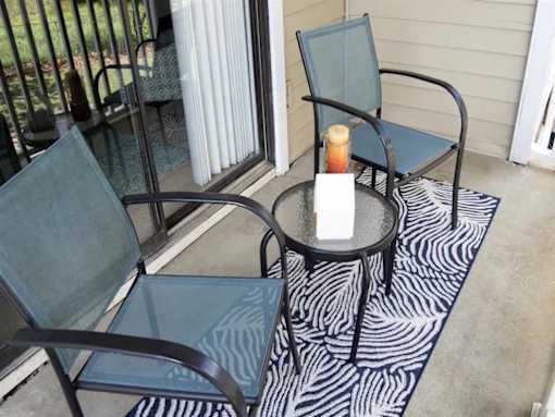 A candle is lit on a table outside at The Madison Apartments and Townhomes, Lawrenceville