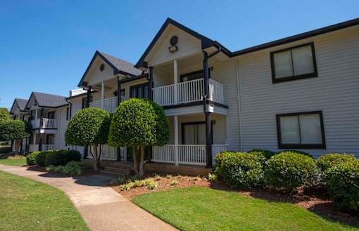 A row of houses with a sidewalk in front at The Madison Apartments and Townhomes, Lawrenceville, Georgia