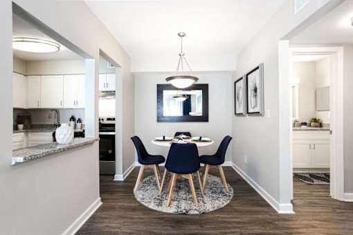 A modern dining room with a round table and chairs at Barcelo at East Cobb Apartments, Marietta, GA